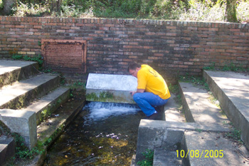 Tim at the mouth of the artesian spring