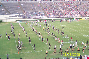 Saints lined up doing stretches and drills