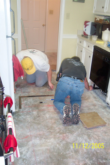 Marking lines on the cement floor in the kitchen