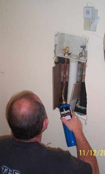 Terry soldering the copper pipe to the washer